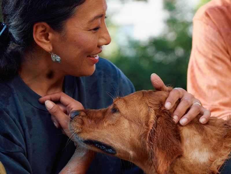 A woman petting a dog